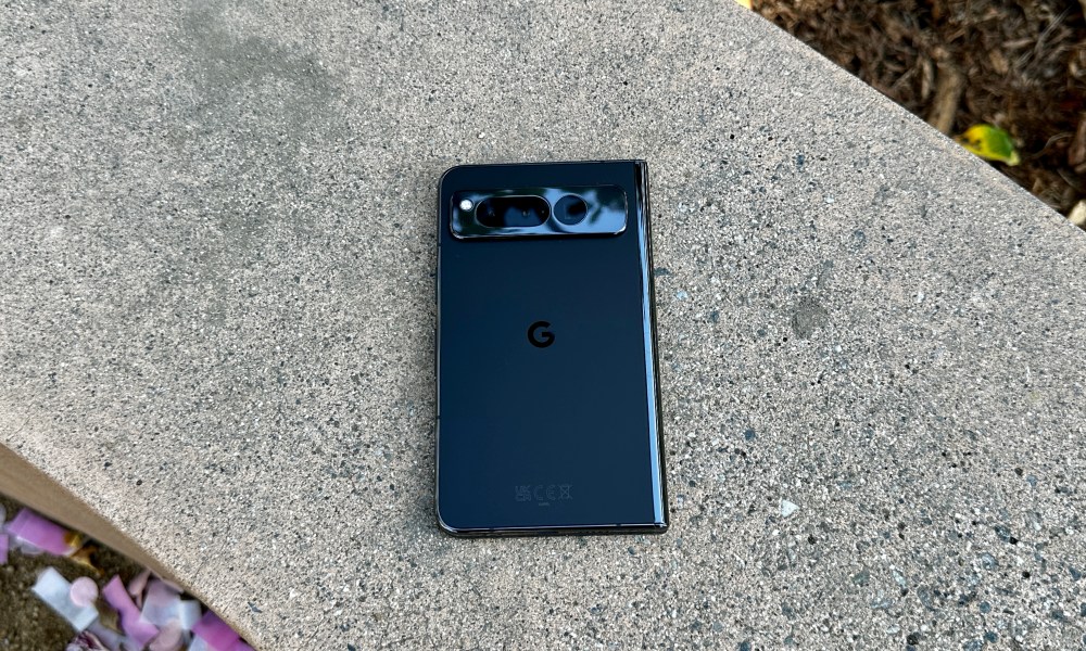 Google Pixel Fold in Obsidian laying on a concrete bench.