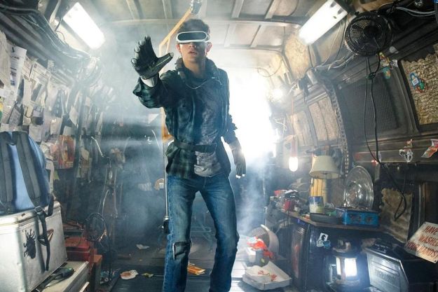 A young man plays with a virtual reality headset in Ready Player One.