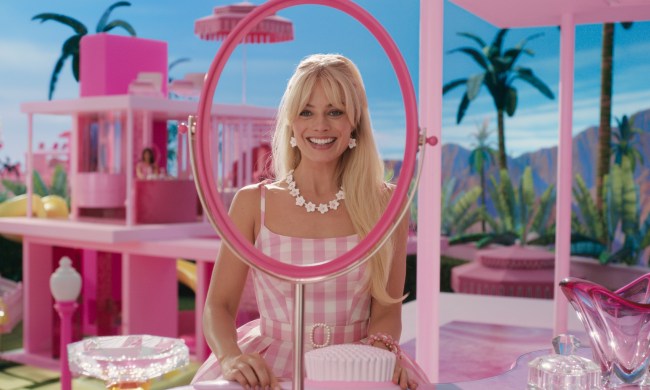 Margot Robbie looks through a mirrorless mirror in Barbie.