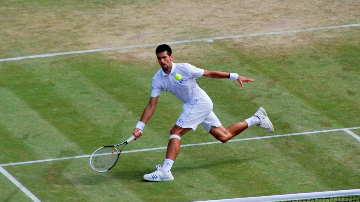 Novak Djokovic hits a ball at Wimbledon.