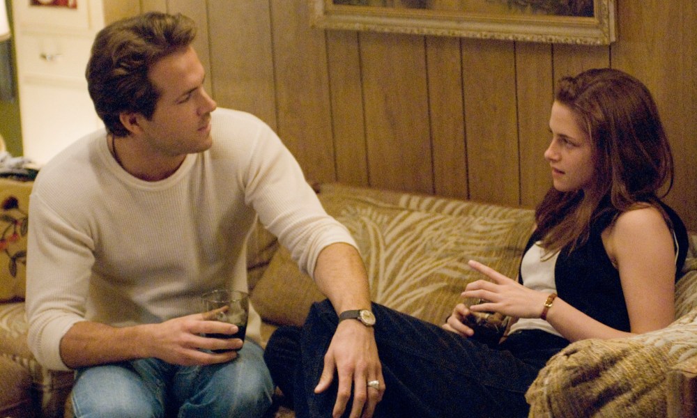 A man touches a woman on the knee in Adventureland.