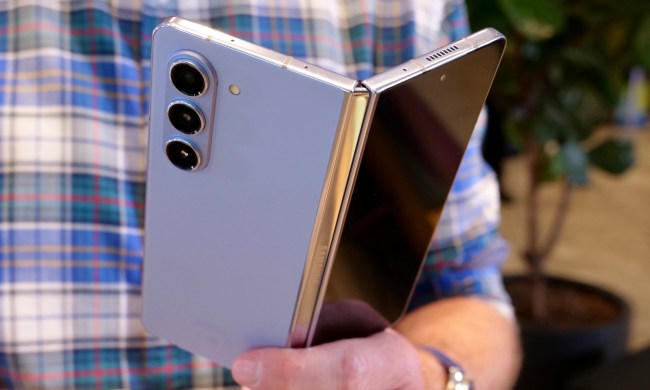 A person holding the half-open Samsung Galaxy Z Fold 5.