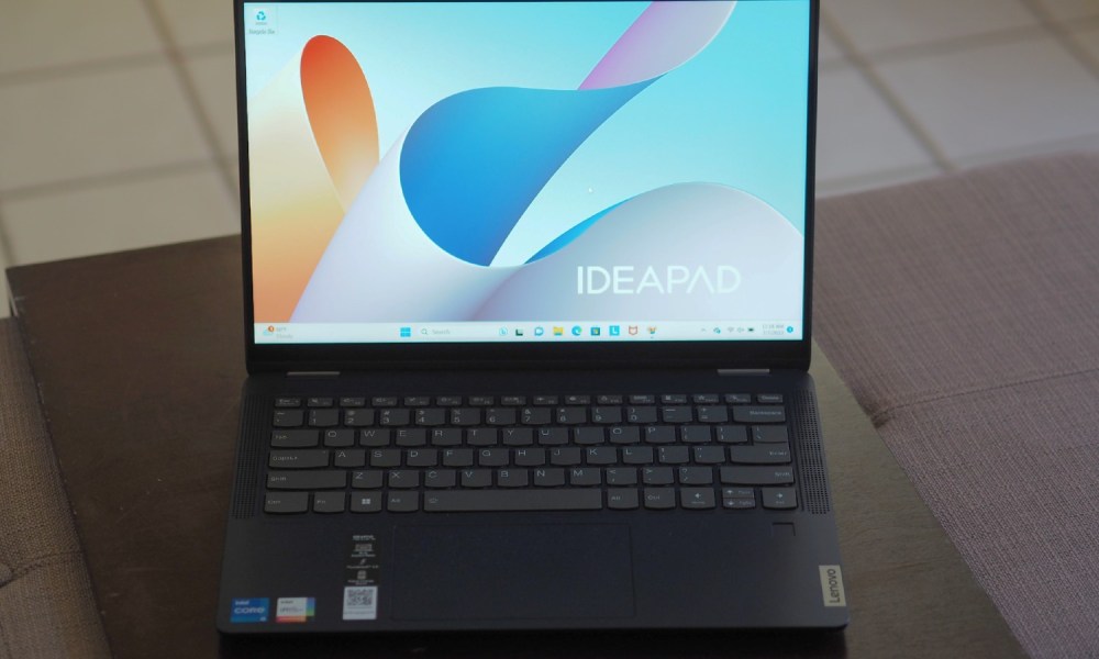 The IdeaPad 14 on a table with the screen on.