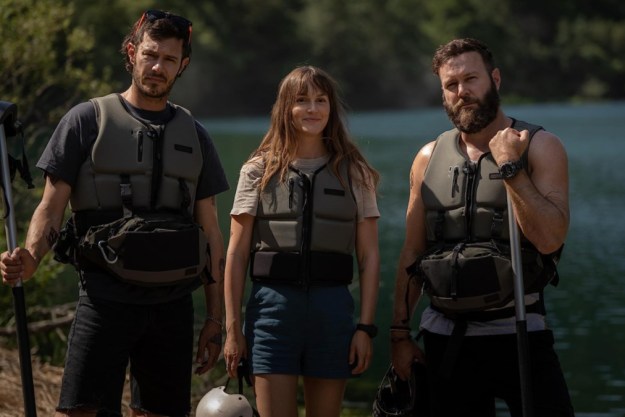 Three people stand in whitewater rafting gear in River Wild.