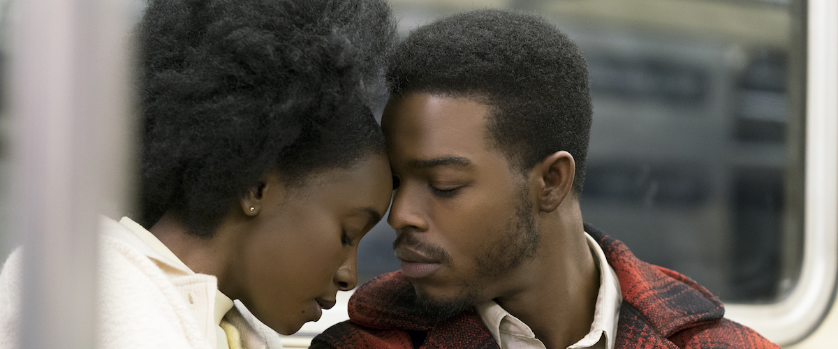 A man and a woman gaze at each other in a subway car in If Beale Street Could Talk.