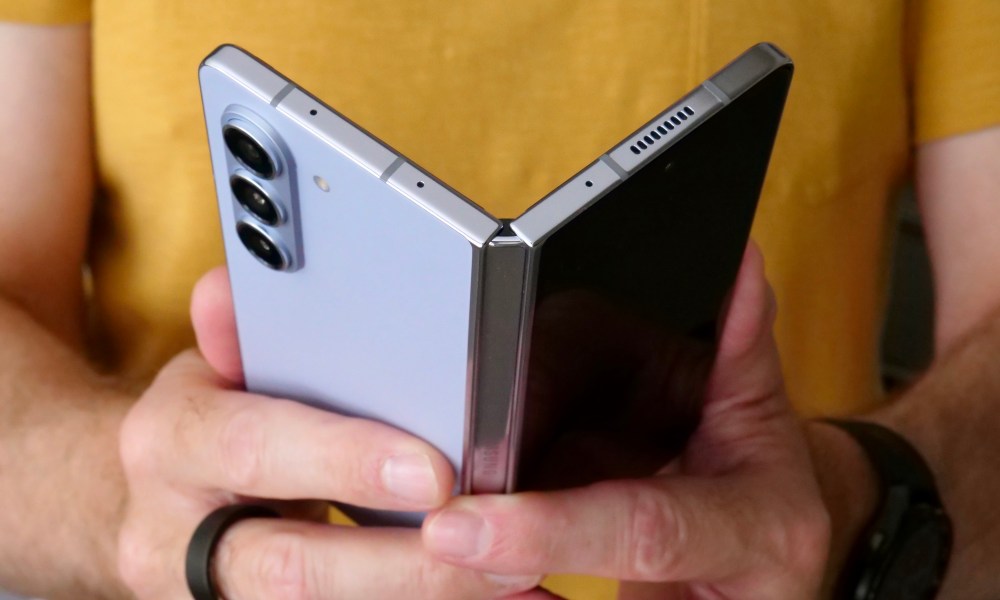 A person opening the Samsung Galaxy Z Fold 5.