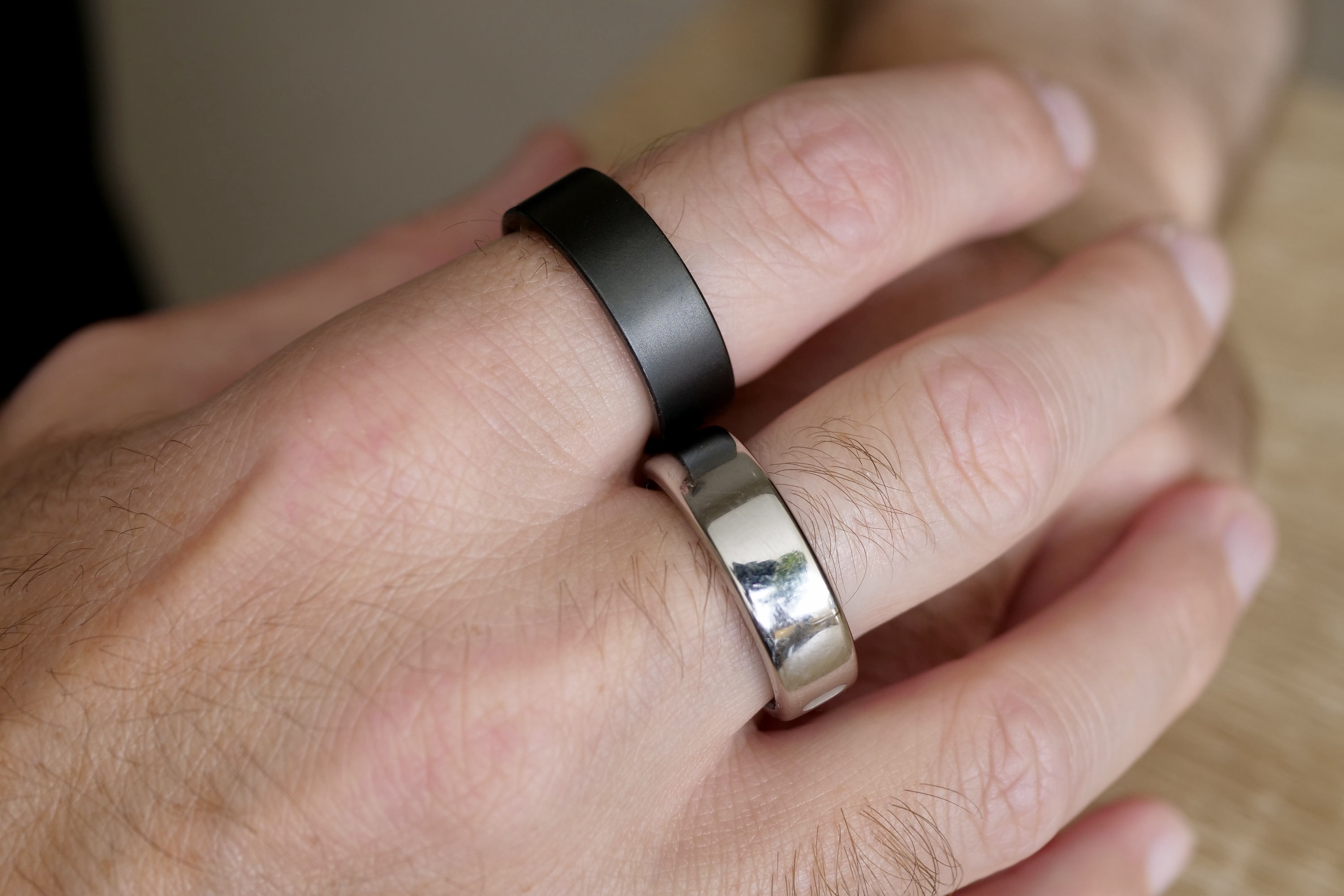 oura ring and ultrahuman ring air on fingers