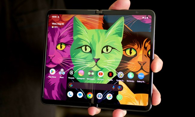 A person holding the Google Pixel Fold with the screen open.