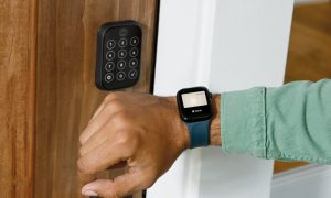 A person opening the Yale Assure Lock 2 with their Apple Watch.