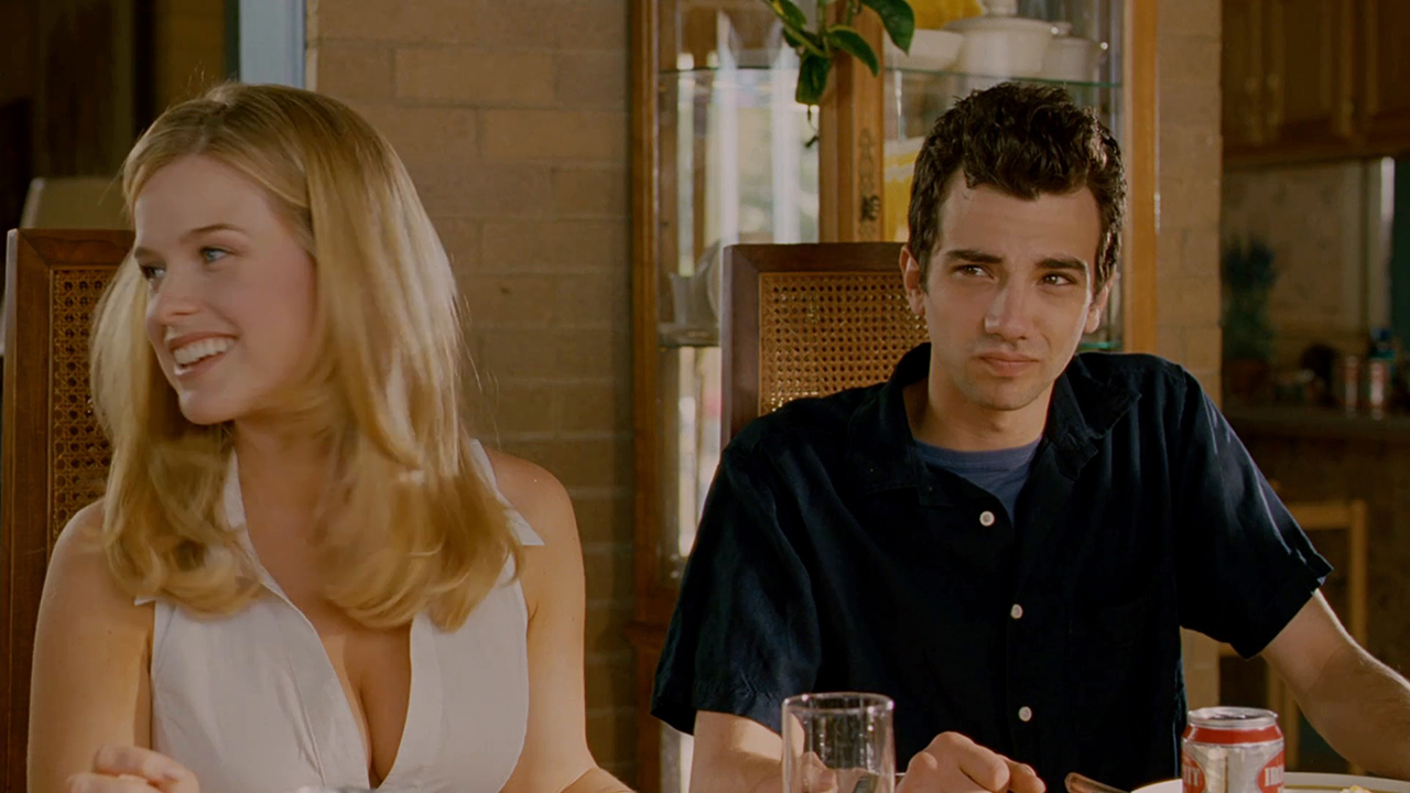 A young woman and man sit together at a table in a scene from She's Out Of My League.