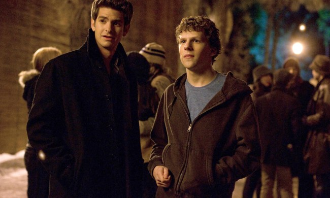 Andrew Garfield and Jesse Eisenberg stand outside together in The Social Network.