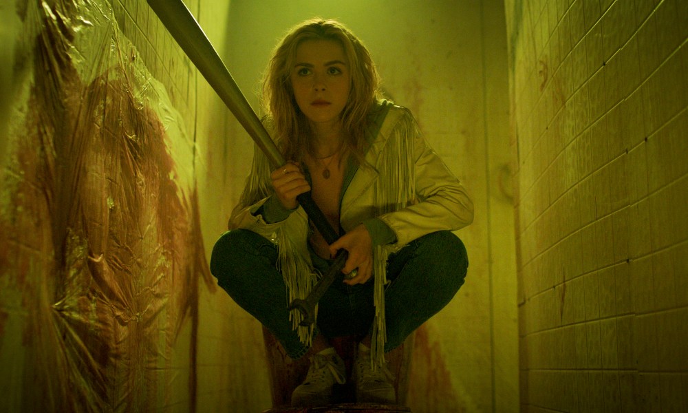 Kiernan Shipka crouches with a bat in Totally Killer.