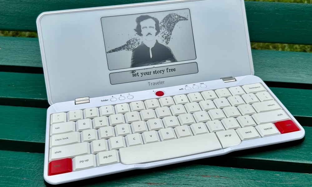 Freewrite Traveler with standby screen on a green park bench.