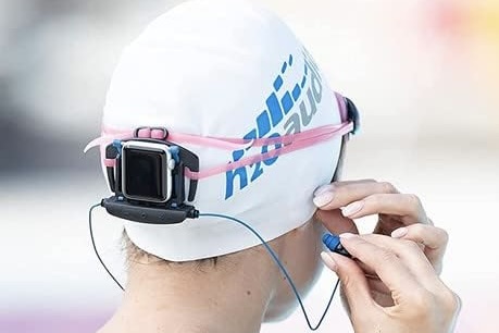 A woman wearing the H20 Audio Interval Swimming Earbuds.