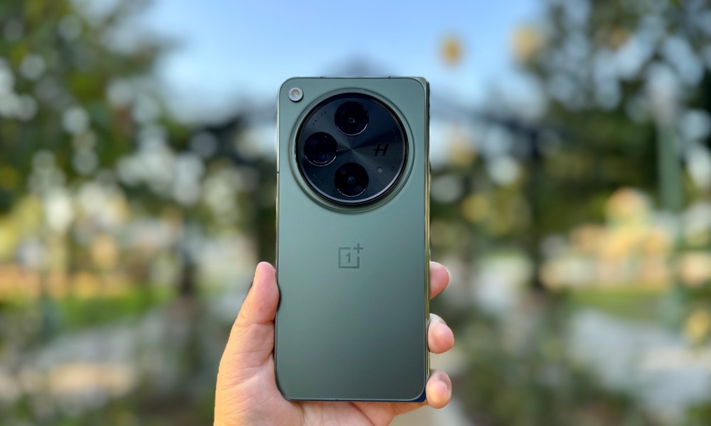 OnePlus Open in Emerald Dusk held in hand.