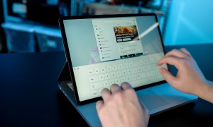 Someone typing on the Surface Laptop Studio 2's touchscreen.