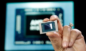 AMD CEO Lisa Su holding an APU chip.