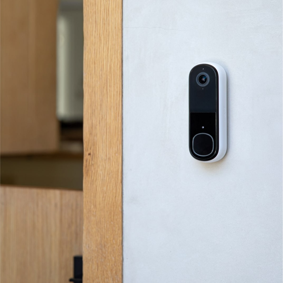 The Arlo Video Doorbell 2nd Gen installed on a white wall.