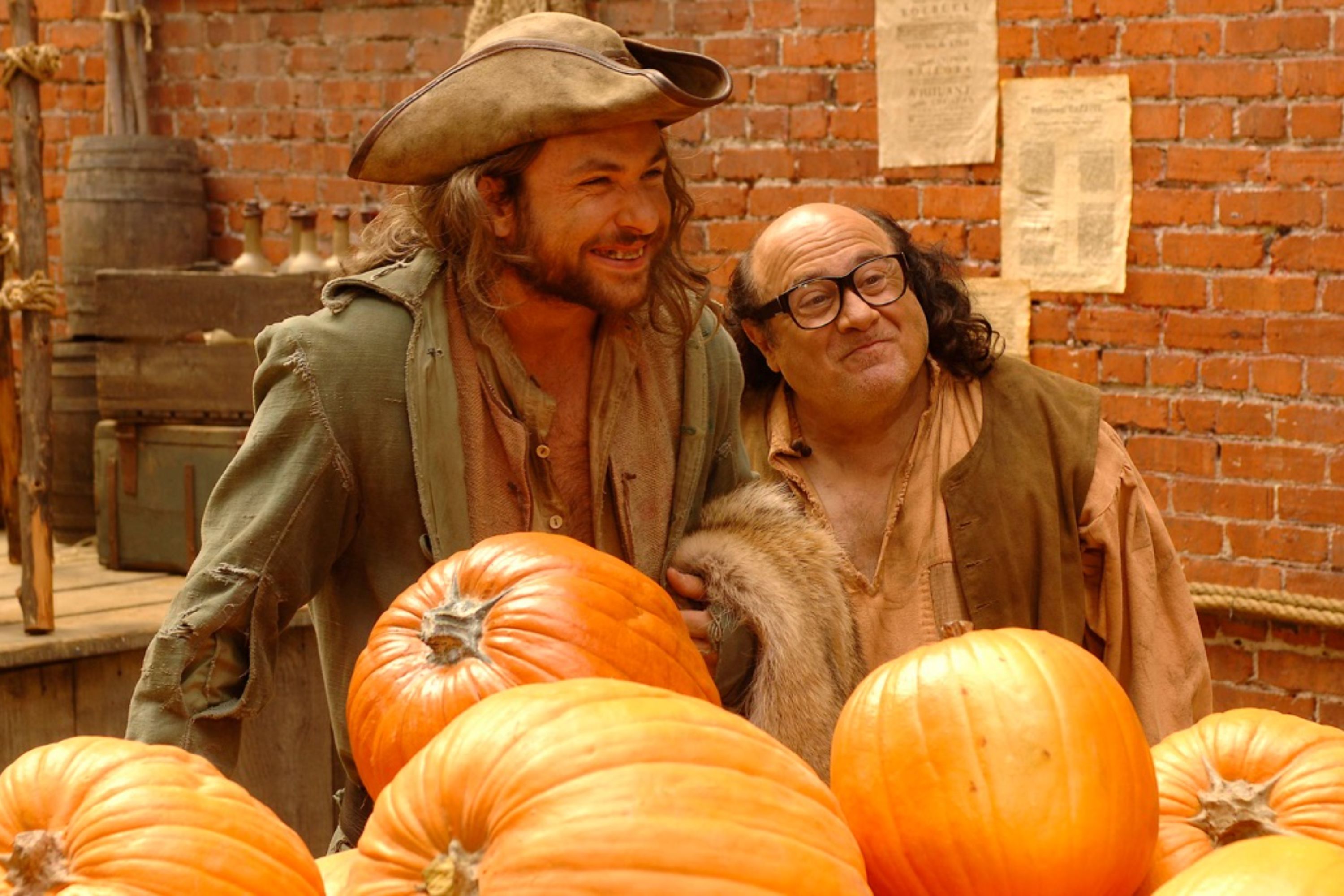 Charlie and Frank standing behind pumpkins in The Gang Cracks the Liberty Bell from It's Always Sunny in Philadelphia.