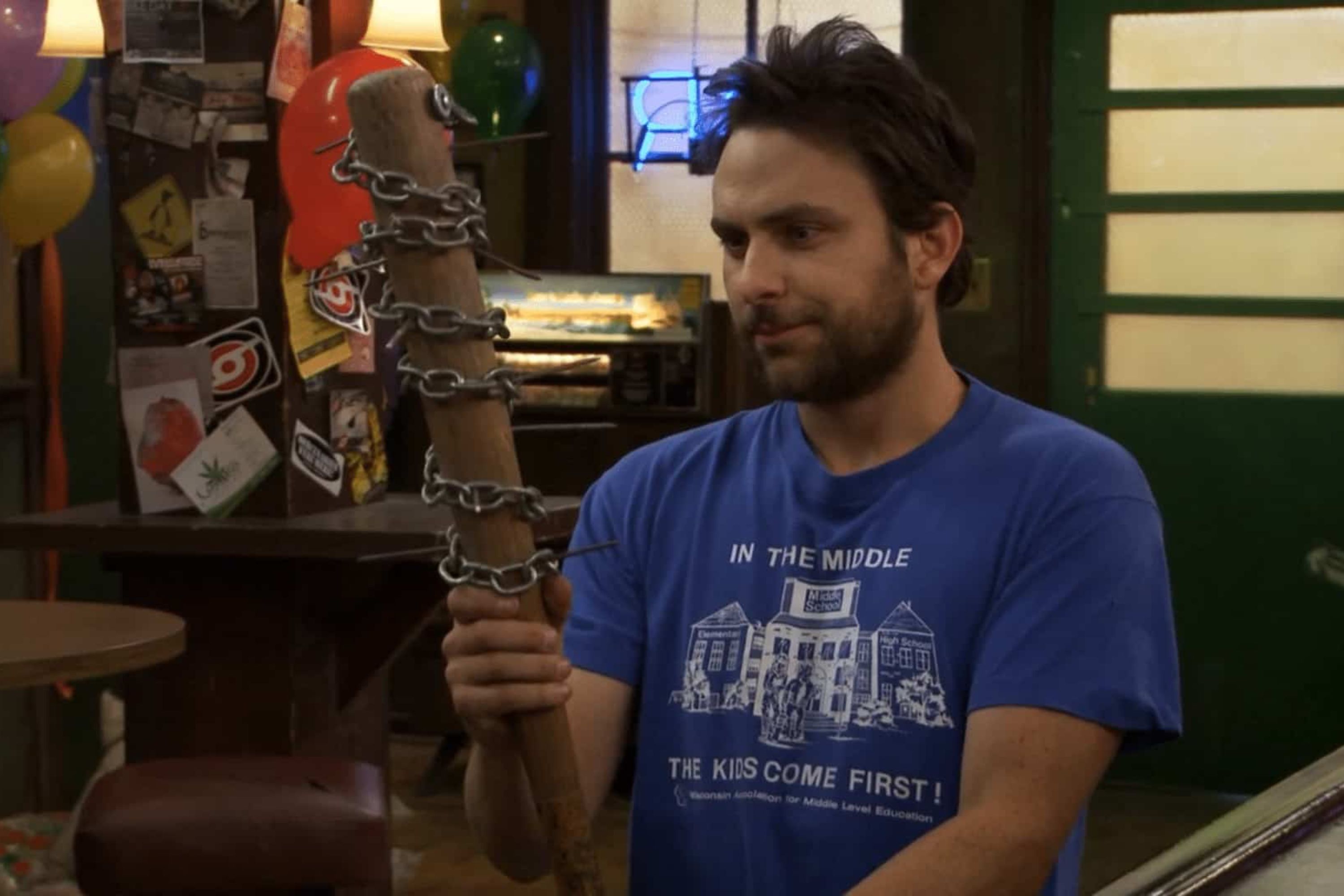 Charlie smiling as he holds a bat covered in chains in Charlie Kelly King of the Rats from It's Always Sunny in Philadelphia.