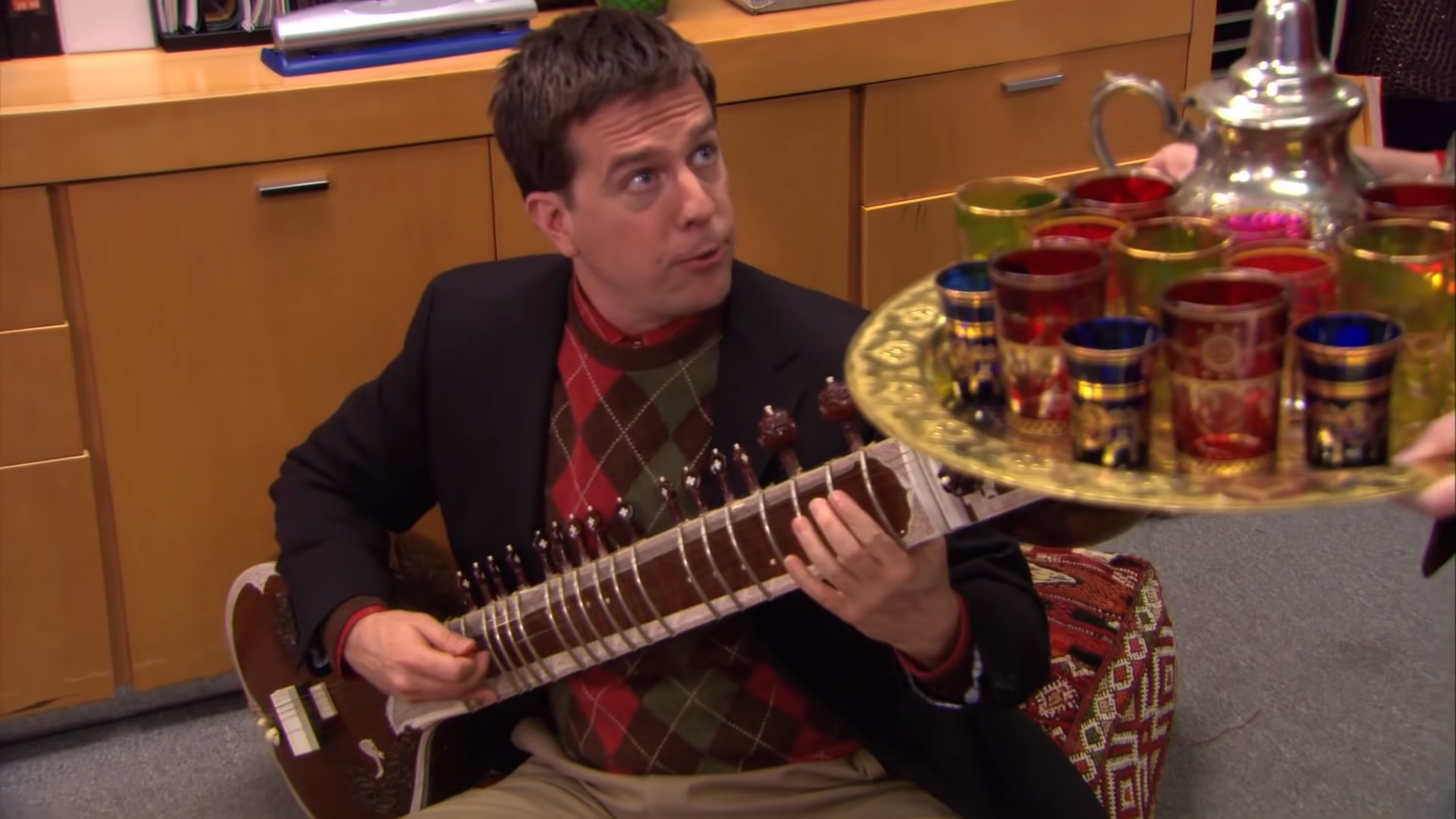 Andy playing a sitar in "The Office."
