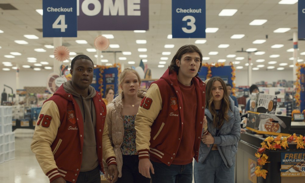 Four teenagers stand in a store together in Thanksgiving.