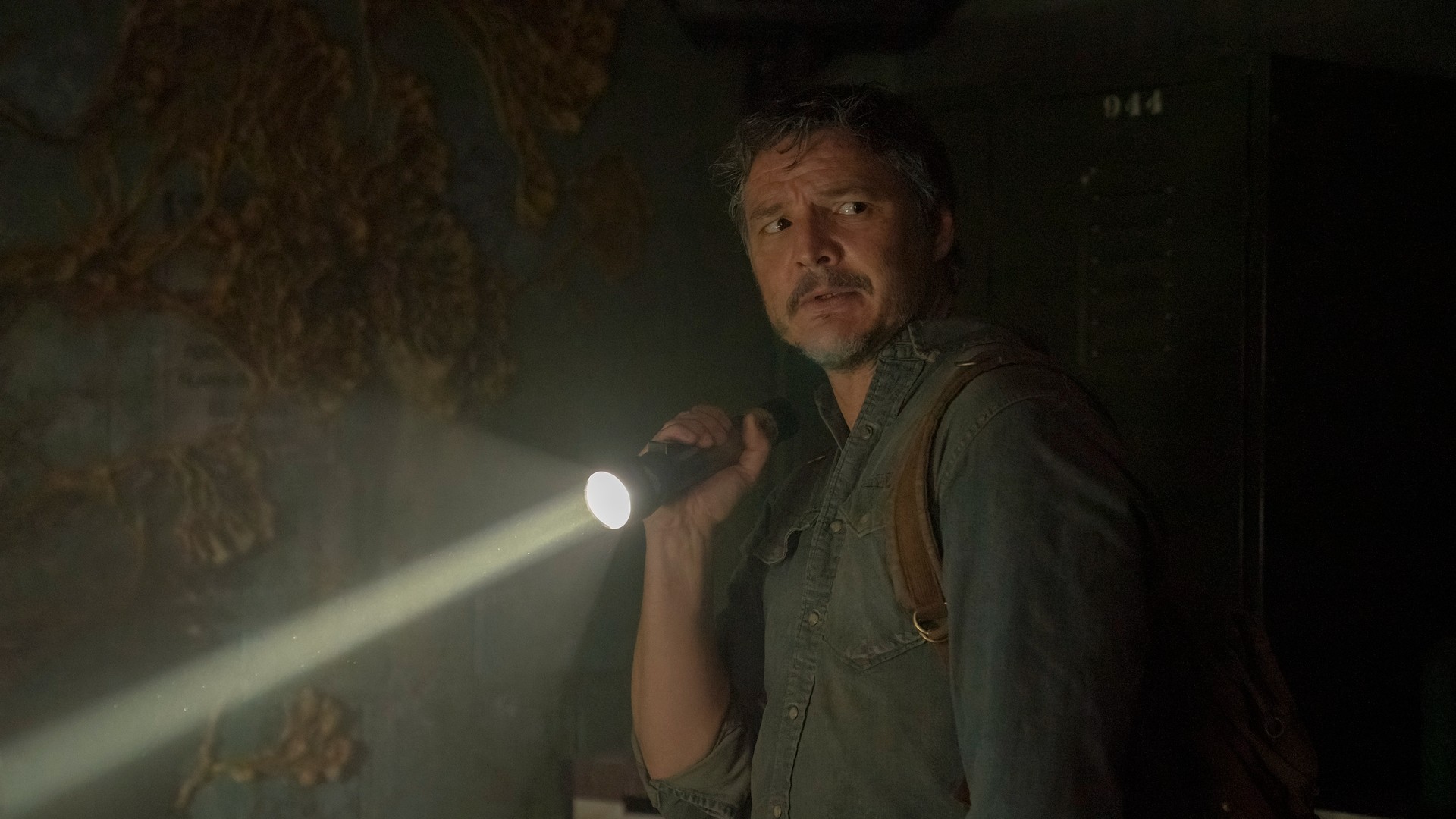 Pedro Pascal shines a flashlight.