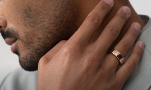 A man wearing the Rose Gold version of the Oura Horizon.