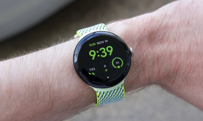 Someone wearing the Google Pixel Watch 2 with a yellow/green fabric band.