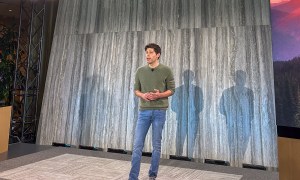 OpenAI CEO Sam Altman standing on stage at a product event.