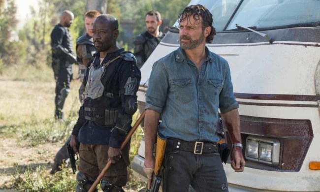 Rick leading his group towards battle, Morgan second in command in a scene from The Walking Dead.