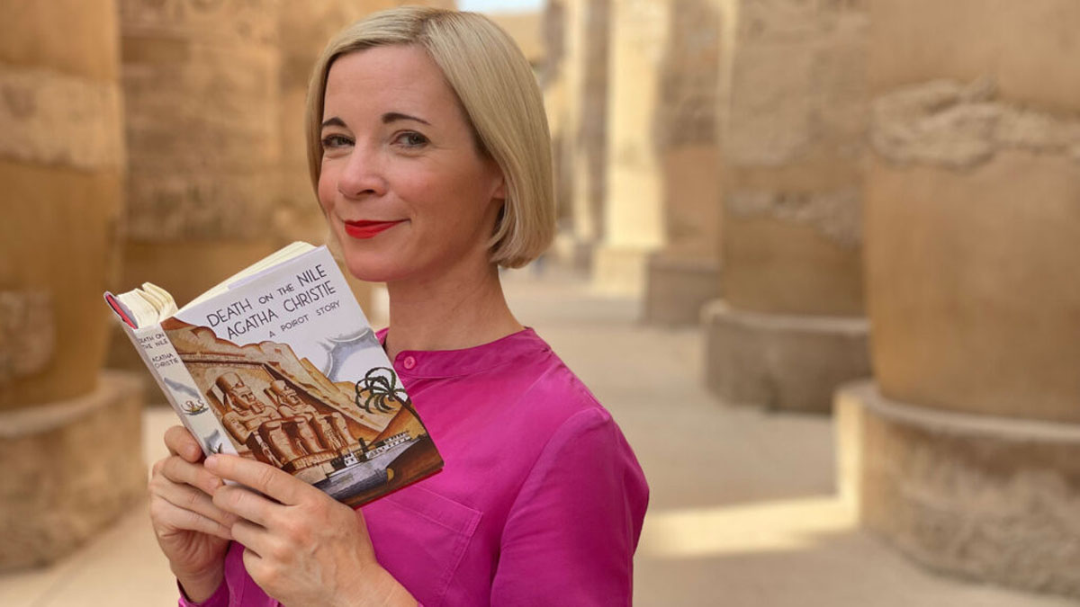 Lucy Worsley holds an Agatha Christy book for Agatha Christie: Lucy Worsley on the Mystery Queen.