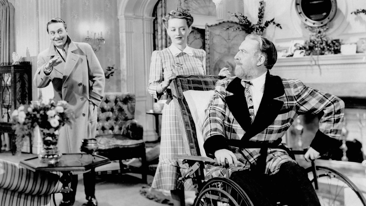 Bette Davis als Maggie drängt Monty Woolley als Sheridan Whiteside in „Der Mann, der zum Abendessen kam“,