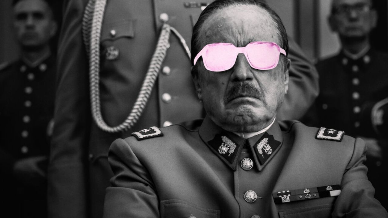 Jaime Vadell as Augusto Pinochet wearing pink glasses while sitting down in the film El Conde.