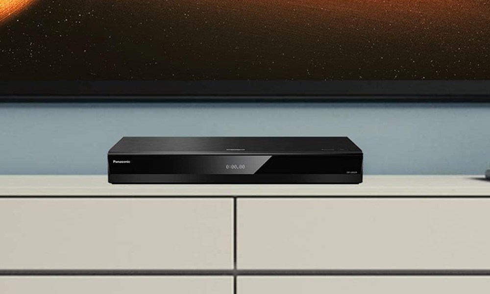 A Panasonic UB820 Blu-ray player sitting on a TV stand.