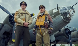 Callum Turner and Austin Butler stand near a plane in Masters of the Air.