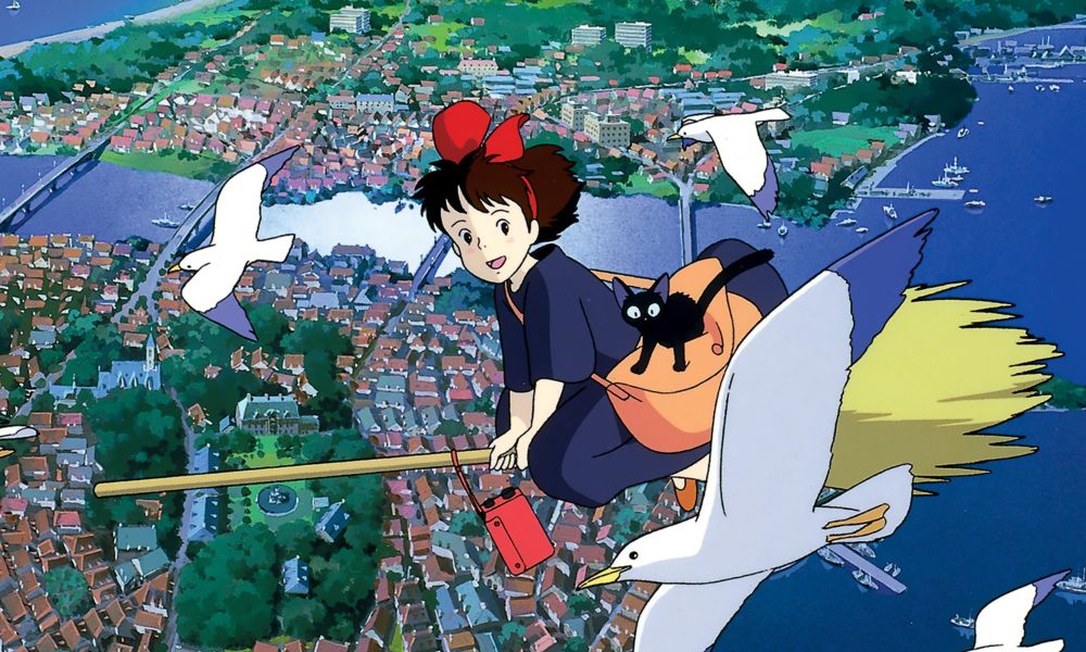 Kiki and her cat flying over the city on her broom in Kiki's Delivery Service.