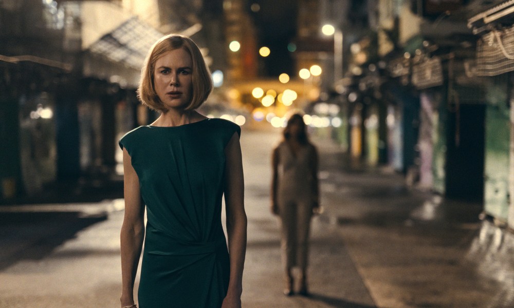 Margaret stands on a Hong Kong street at night in Expats.