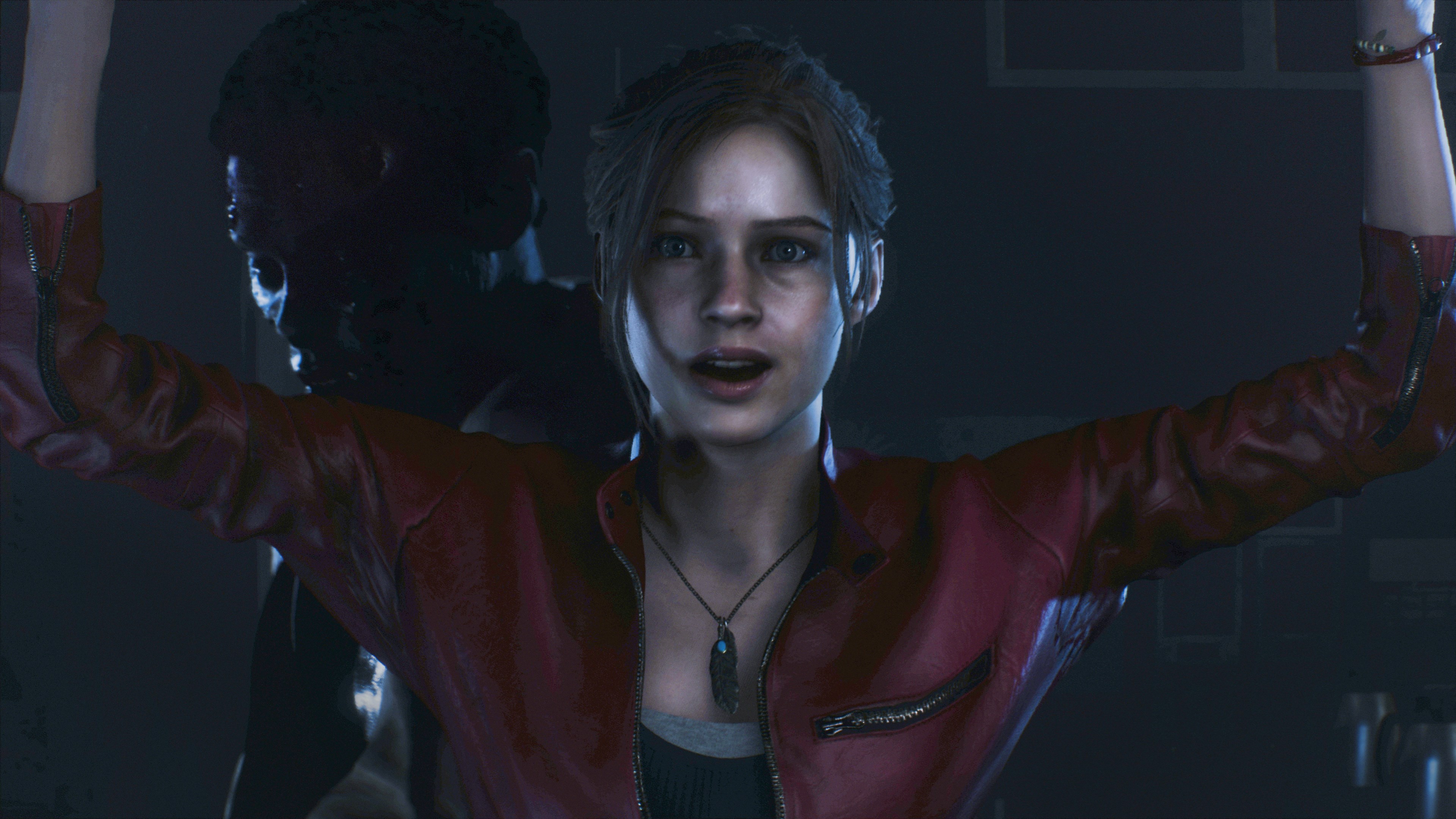 Claire opens a door in Resident Evil 2's remake.