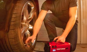 A man fills a tire with air with the Craftsman V20 portable tire inflator.