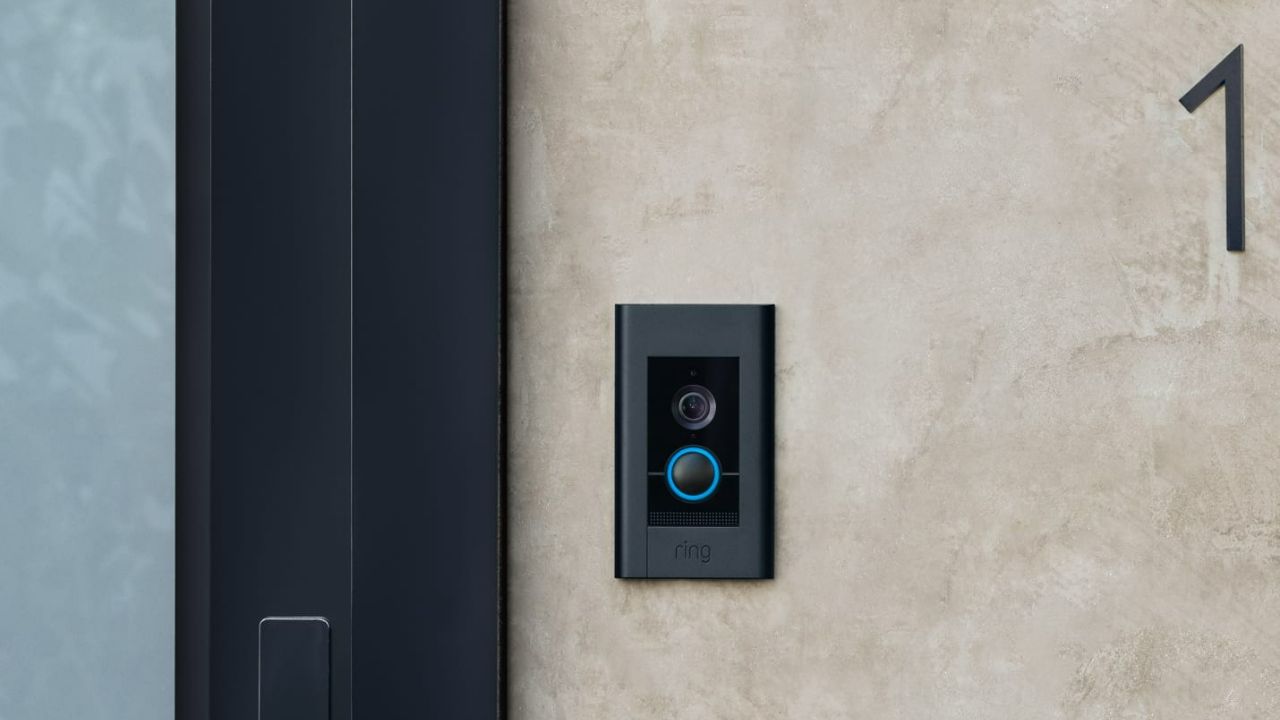 The Ring Elite in black installed by a door.