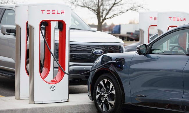 Ford EVs at a Tesla Supercharger station.