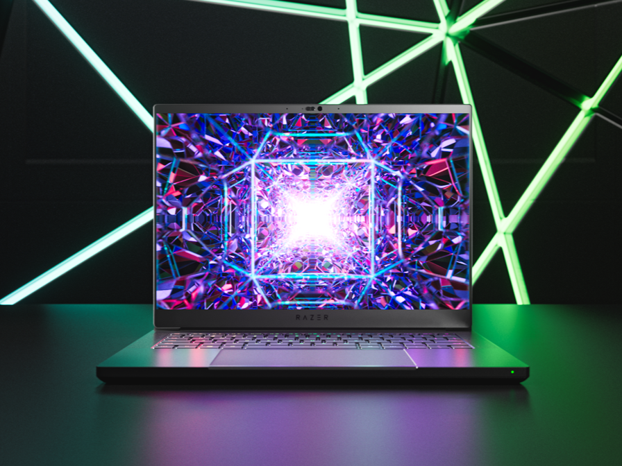 Razer Blade 14 2023 on desk with lighting in background