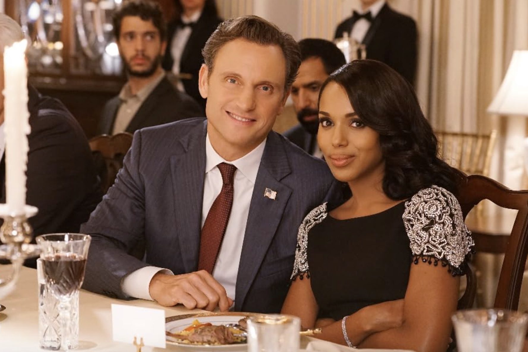 A man and woman sit down at a table and pose for a photo.