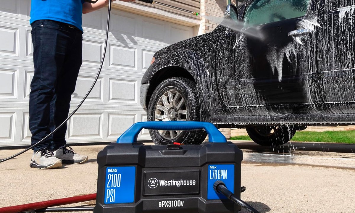 A man washes his truck with the Westinghouse ePX3100v Electric Pressure Washer.