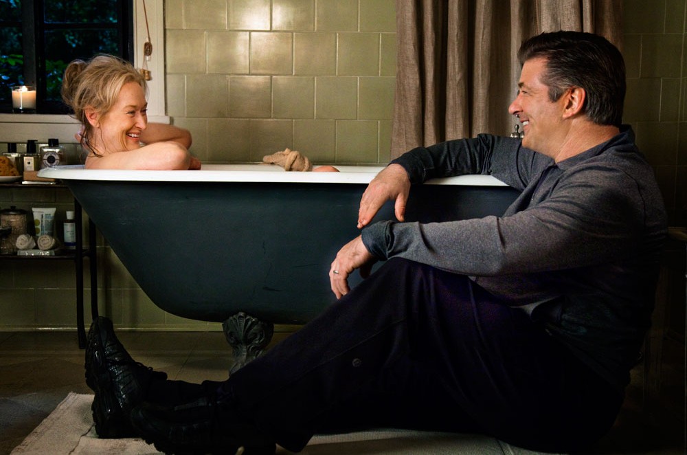 A man sits next to a woman in a bathtub in It's Complicated.