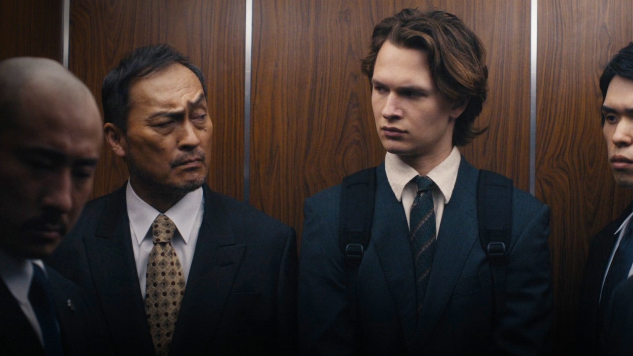 Two men stare at each other in an elevator at Tokyo Vice.