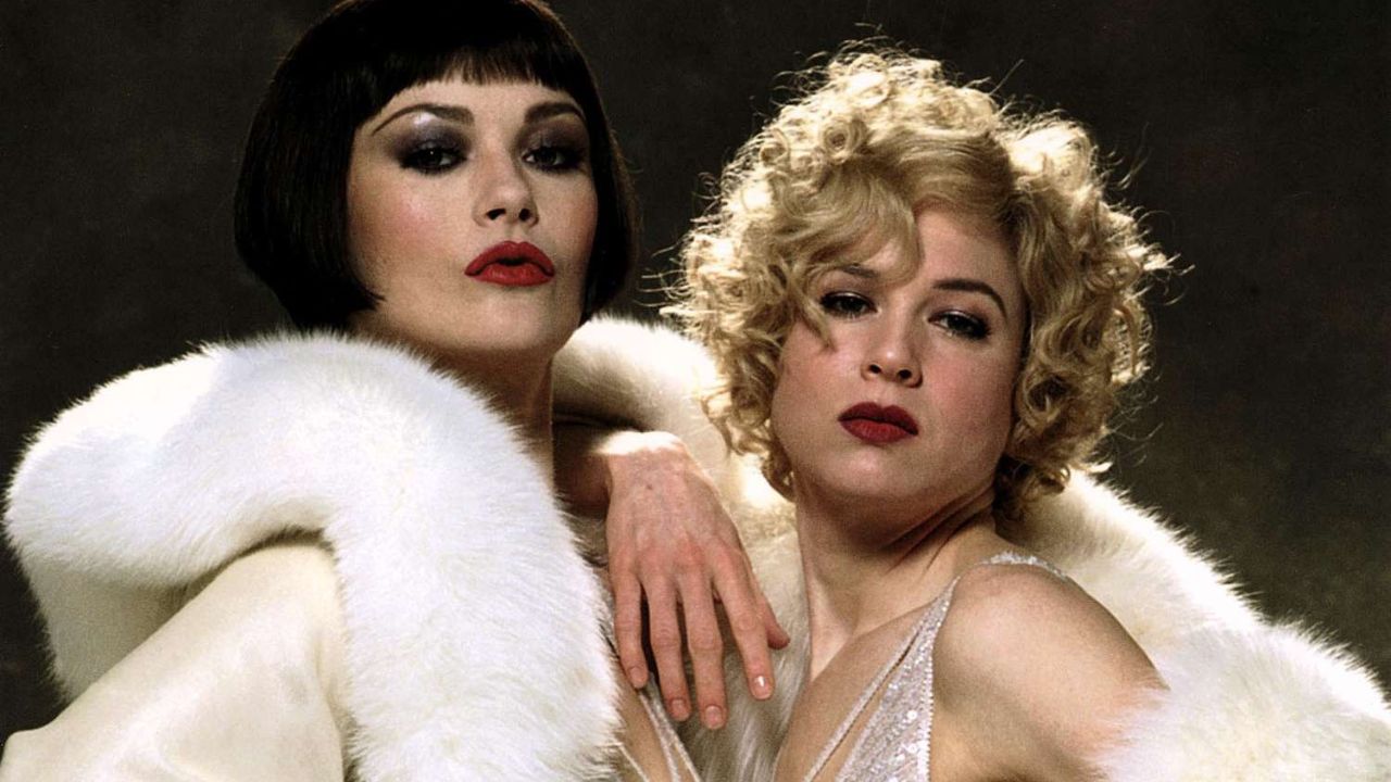 Catherine Zeta-Jones and Renée Zellweger as Velma Kelly and Roxie Hart posing for a photo in Chicago.