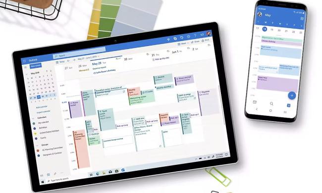 A tablet and a phone showing the calendar feature in the Outlook app.