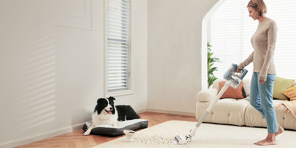 The Tineco cordless vacuum being used in a living room.